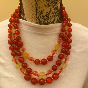 Red, clear acrylic triple strand necklace , gently worn